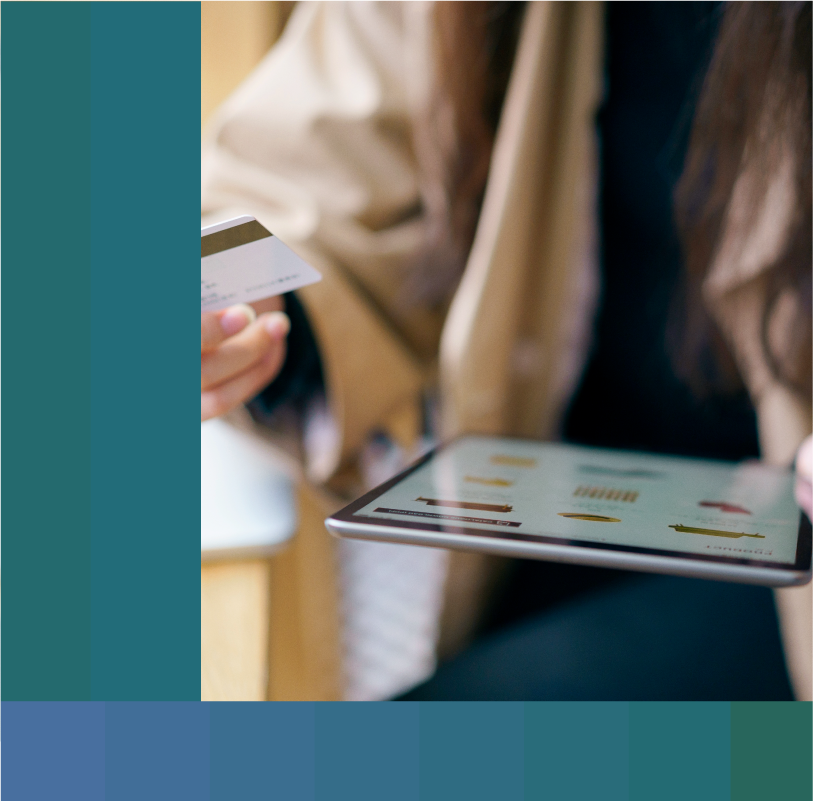 Close-up of woman holding an iPad and credit card