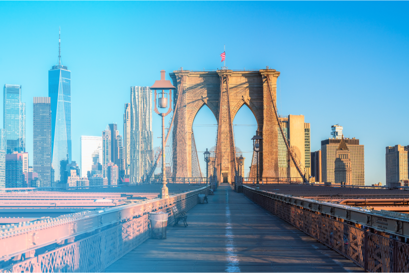 Brooklyn Bridge with Manhattan skyline at sunrise